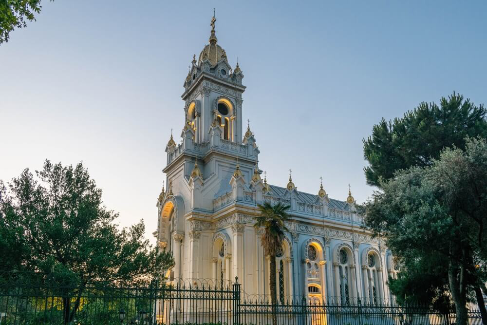 Bulgarian Church: A close-up of the elaborate white stone church surrounded by trees