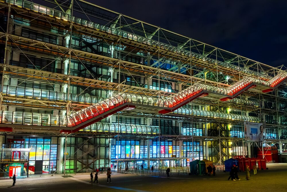 Centre Pompidou: A big glass building lit up at night