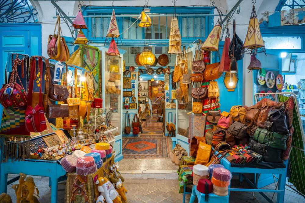 Things to do in Tunisia: A blue store in the souk in Tunis full of colourful wares