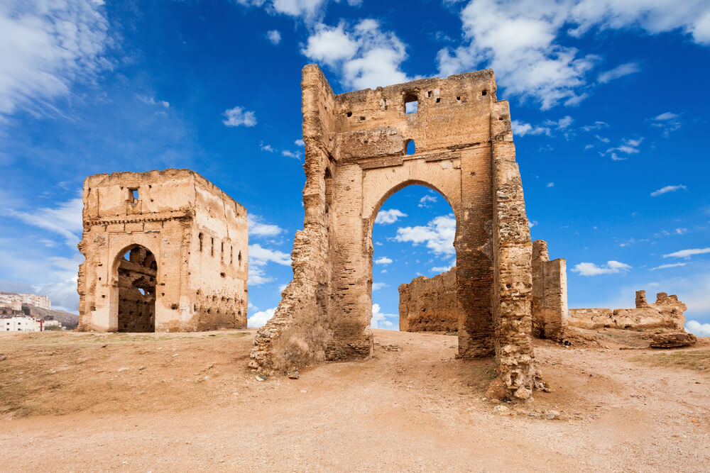 Merenid Tombs: Stone ruins of an ancient mausoleum on sandy ground