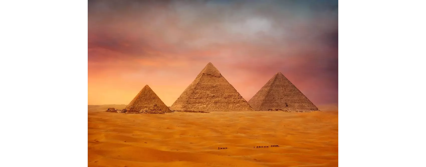 Tourist attractions of Egypt: three pyramids against a pink sunset