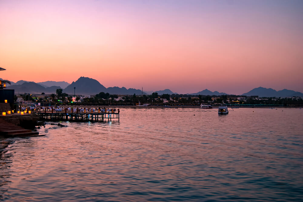 Unique places in Egypt: Naama bay from a distance, across the water at sunset