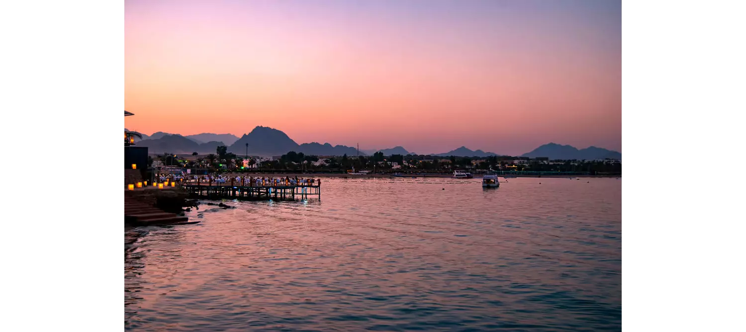 Unique places in Egypt: Naama bay from a distance, across the water at sunset