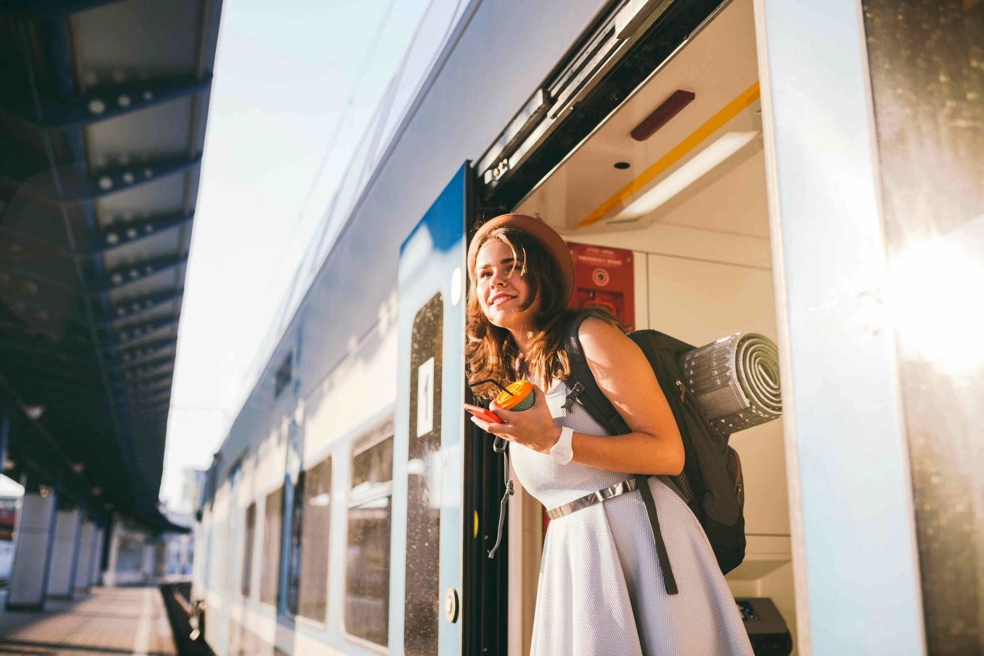 Train journeys in Spain: Woman in the door of a train inside a station