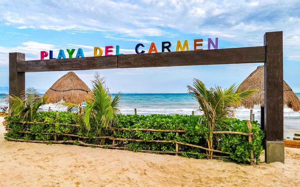 Travel through Mexico: A Playa del Carmen sign on the beach 
