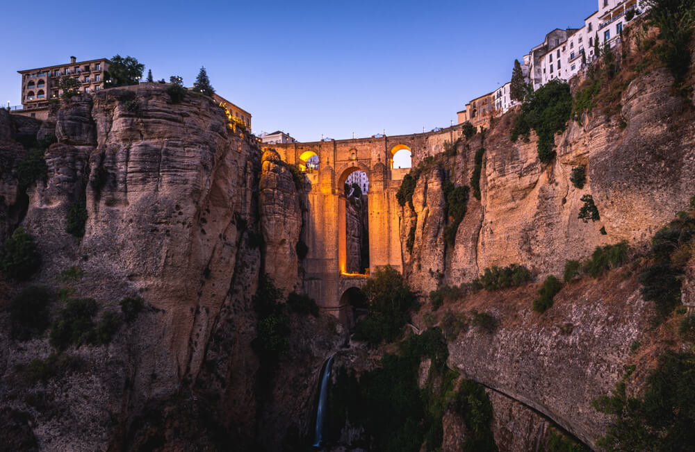 Andalusia: A gorge with a stone bridge between it in Ronda