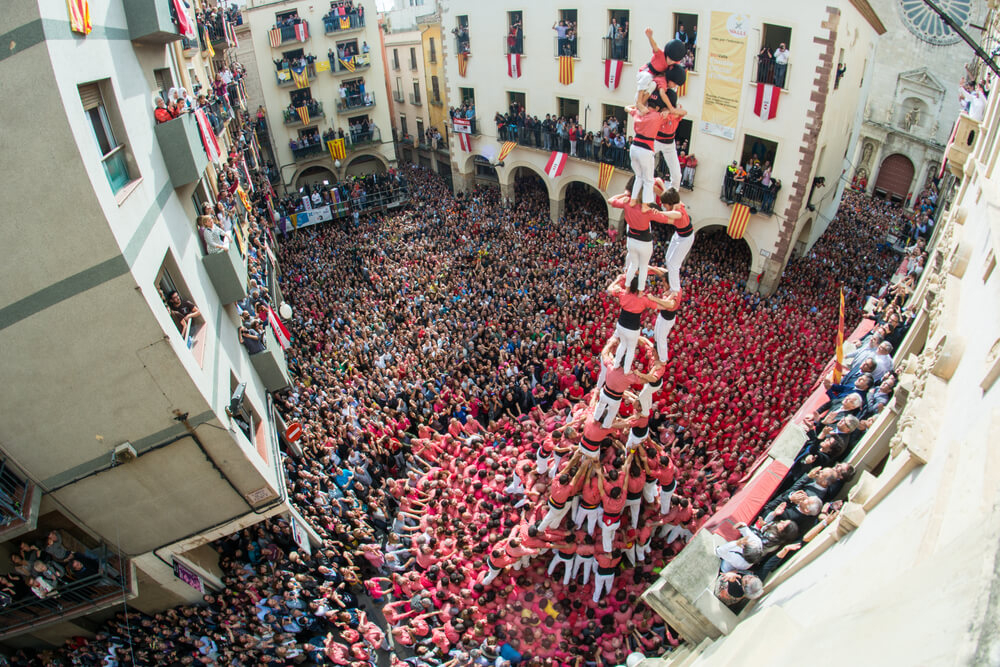 Castellers Barcelona: A bird’s eye view of a square filled with people watching the human towers