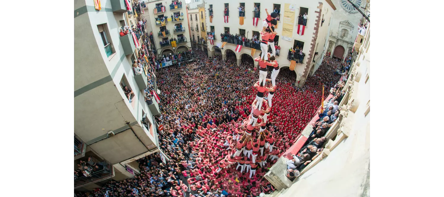 Castellers Barcelona: A bird’s eye view of a square filled with people watching the human towers