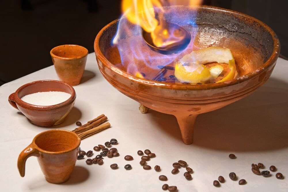 Quemaida Gallega: A ceramic pot with flaming alcohol, lemon and coffee beans