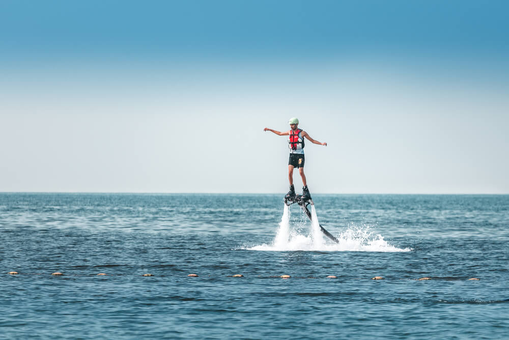 Water sports in Dubai: A man flyboarding in Dubai at sunset