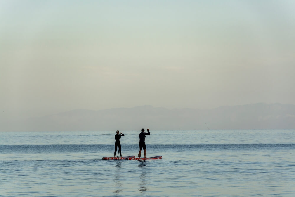 Watersports in Tenerife: Two people paddle boarding on open water