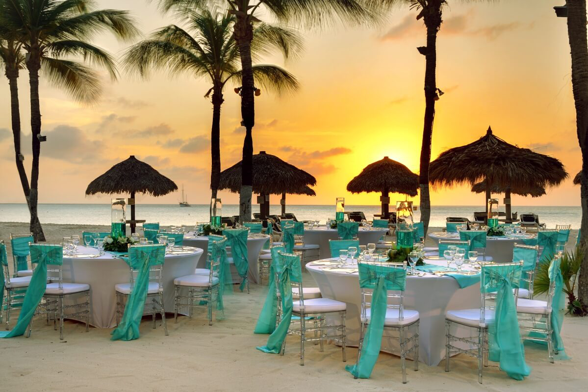 Aruba: Sunset on a white sand beach with wedding tables