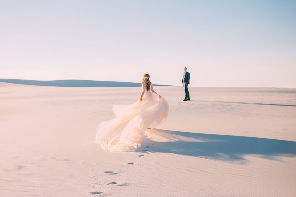Dubai: A woman in a wedding dress running across the sand to a man in a suit