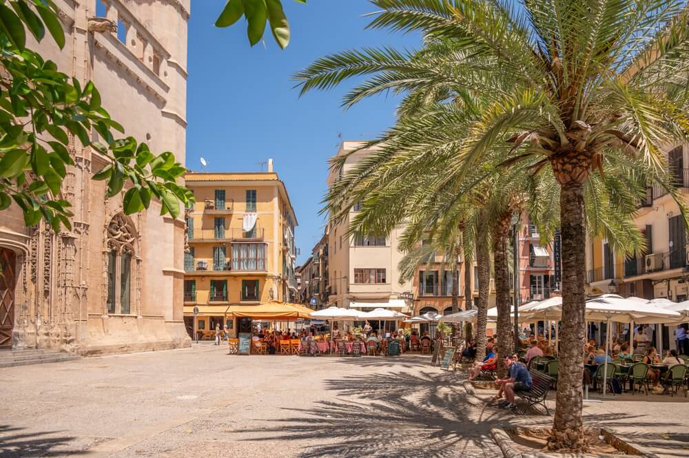 Weekend in Palma: An old town square with ornate sandstone buildings