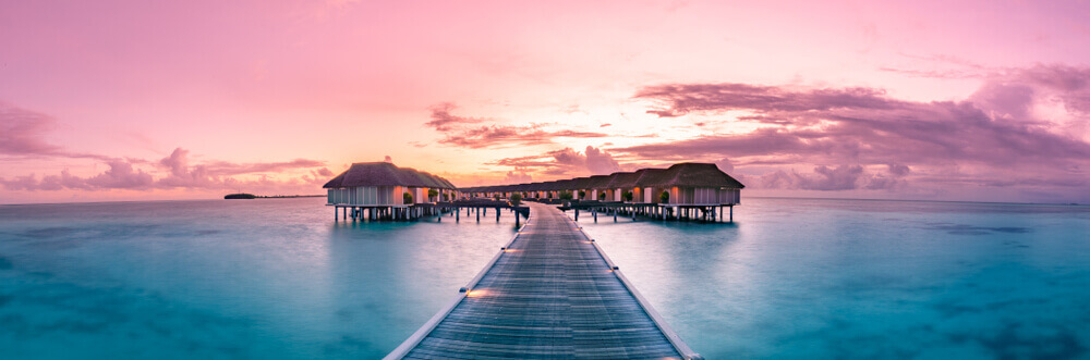 Maldives hotels: Sunset over a collection of villas in the pink Ocean