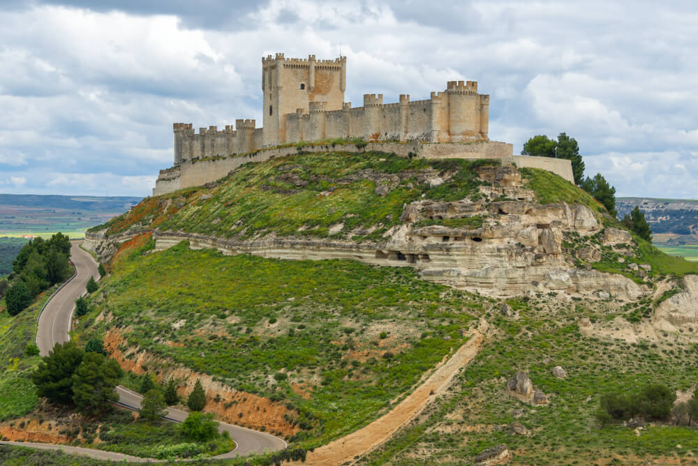 Wine regions of Spain: The Peñafiel Museum of Wine on a hill surrounded by green