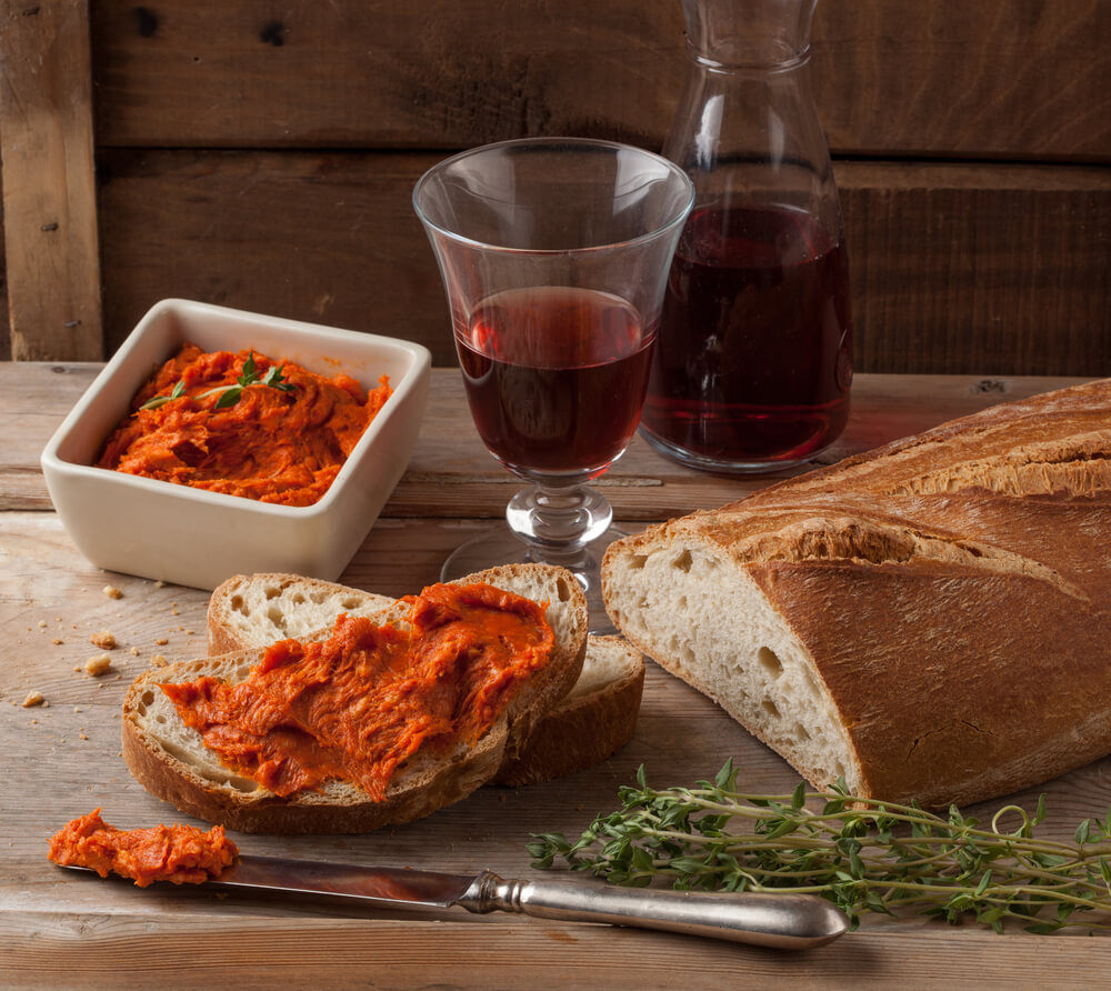 Wine Tours Mallorca: A glass of red wine and a plate of sobrasada and bread