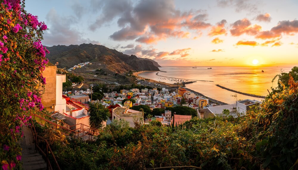 Winter Sun Destinations: The sun setting over Las Teresitas beach seen from the village