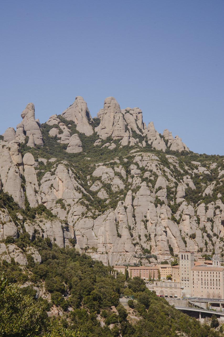 View of Montserrat mountain with its rock formations and the monastery at its base.