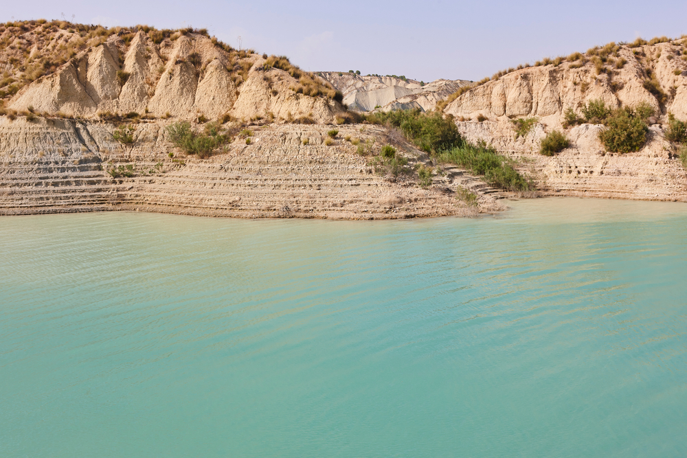 Badlands landscape and blue waters in Algeciras reservoir. Murcia, Spain