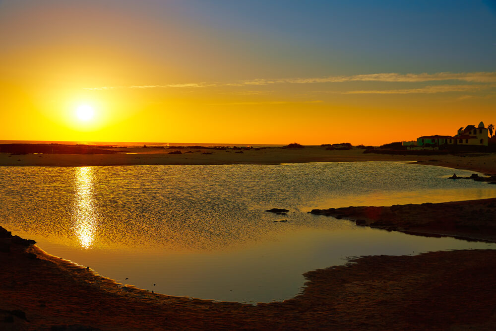 Best beaches in Fuerteventura: Sun setting over the sandy La Concha Beach