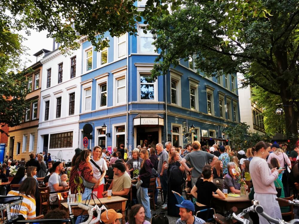 Best holidays for teenagers: A blue bar on a street corner with a group of young people outside