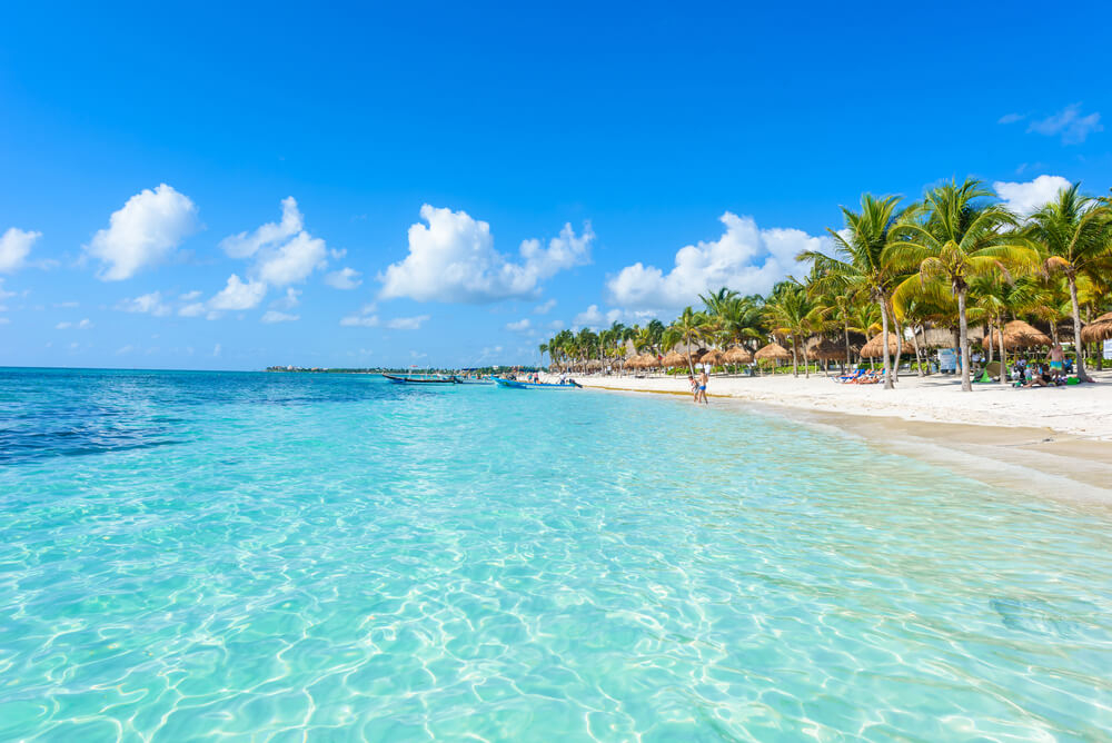 Cancun beach: A close-up of the white sand beach with topaz waters in Cancún