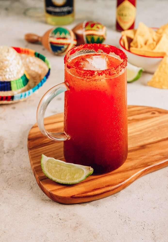 A michelada is made with Mexican lager, tomato juice, and spices.