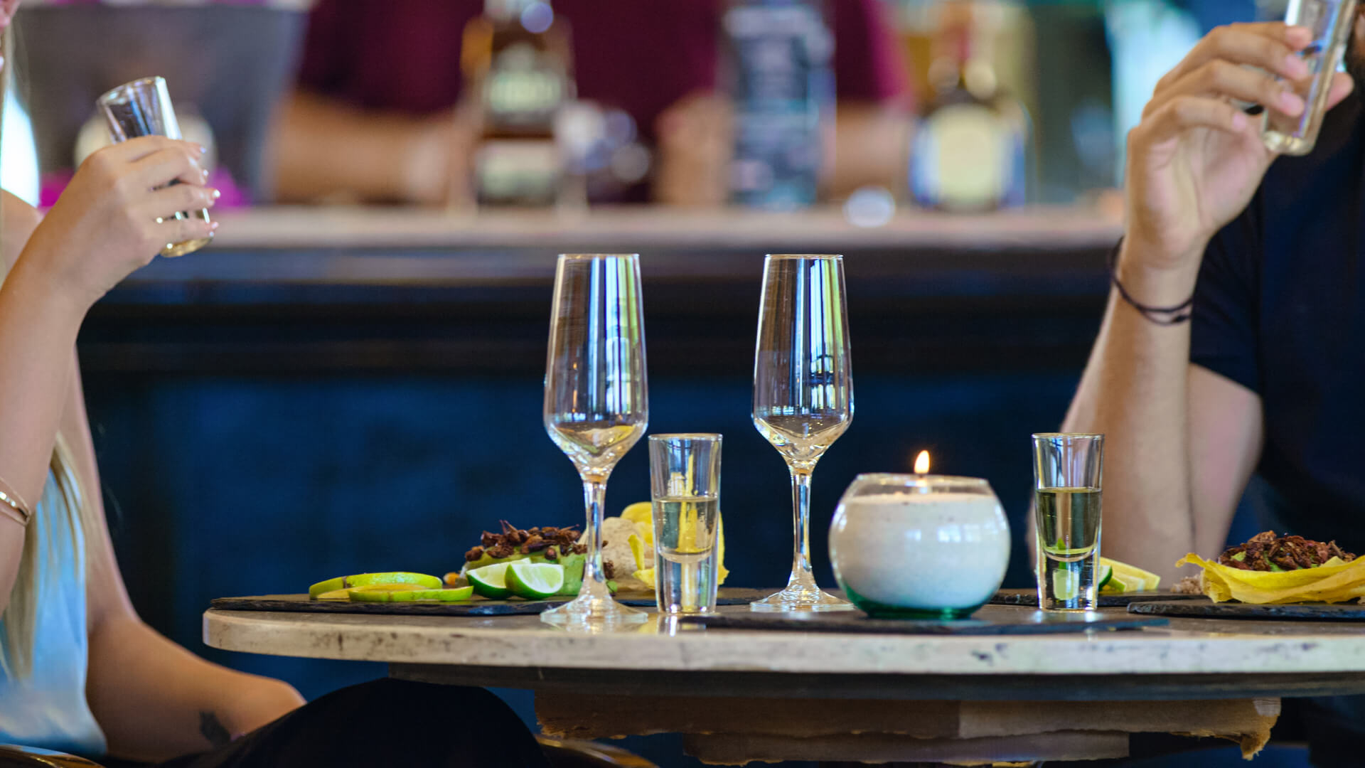 Caribbean cocktails: Two people drinking tequila and eating Mexican food at Royal Hideaway Playacar