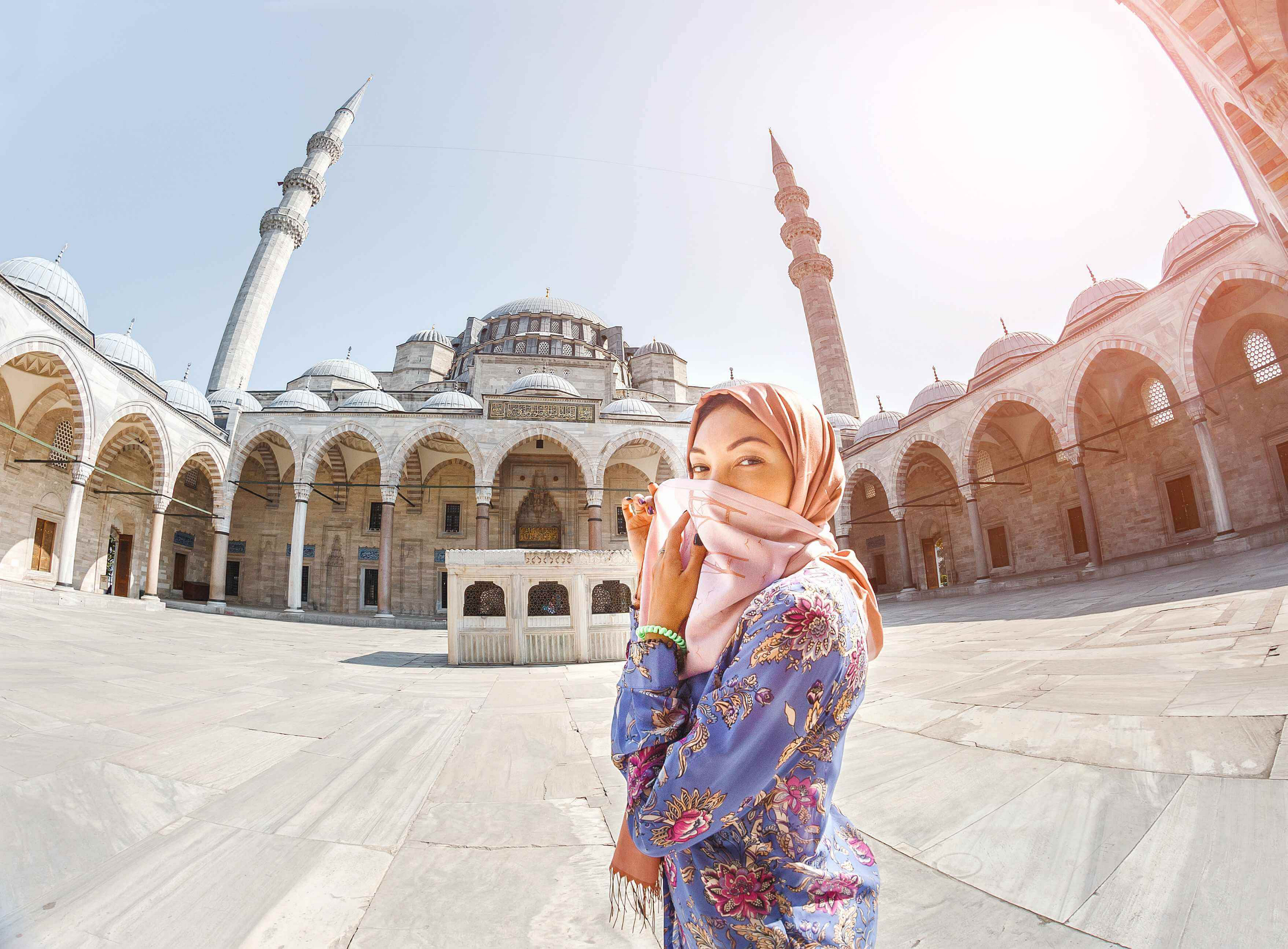 Eid al Fitr Celebrations: A woman in a headscarf in front of a mosque