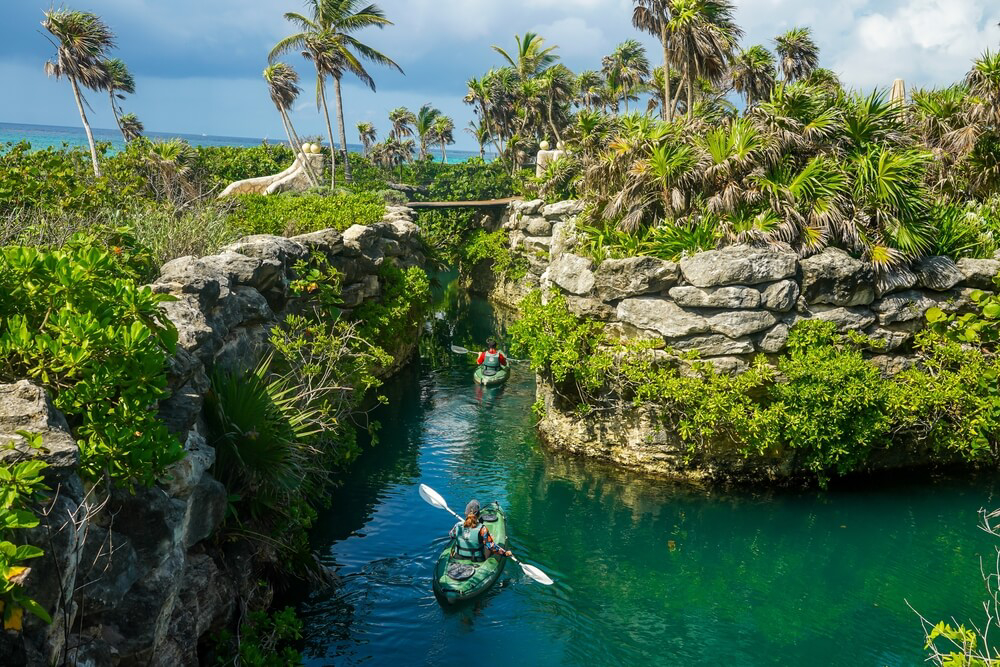 Xcaret, Riviera Maya: Two people kayaking through a rocky waterway 