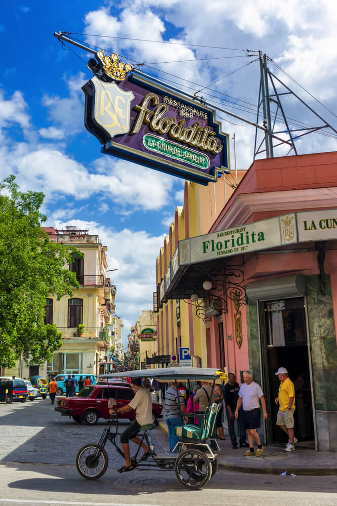 La Floridita: A corner street view of the iconic sign and pink facade of La Floridita, Havana