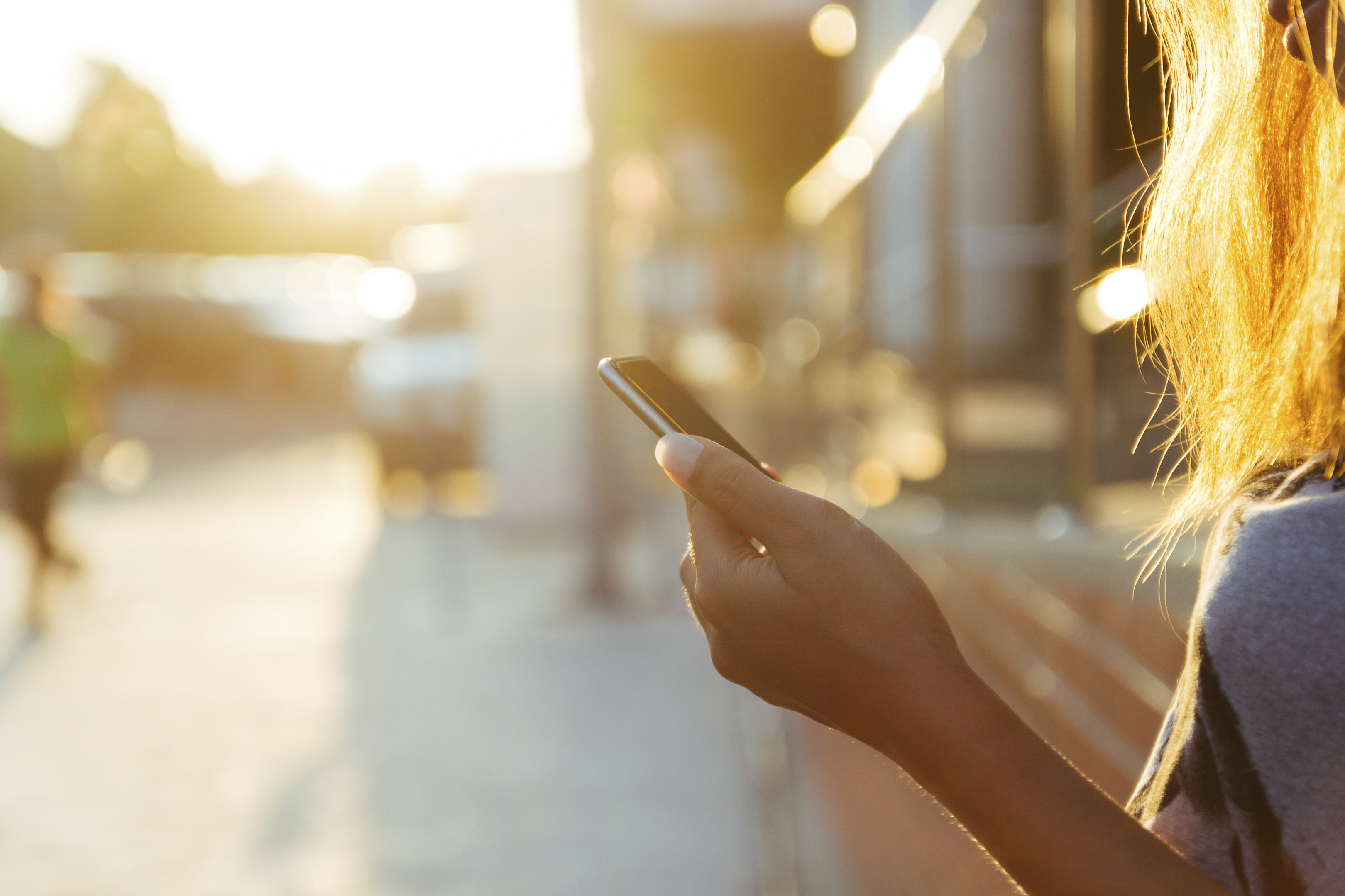 closeup women using smartphone at sunset