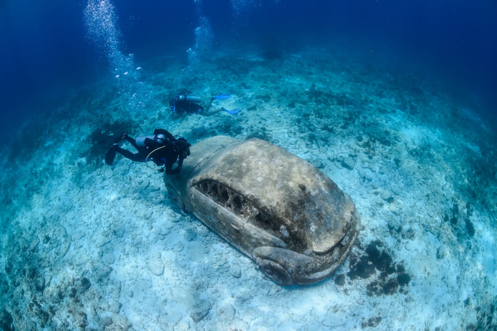 Cancun places to visit: Person scuba diving at the MUSA open water museum