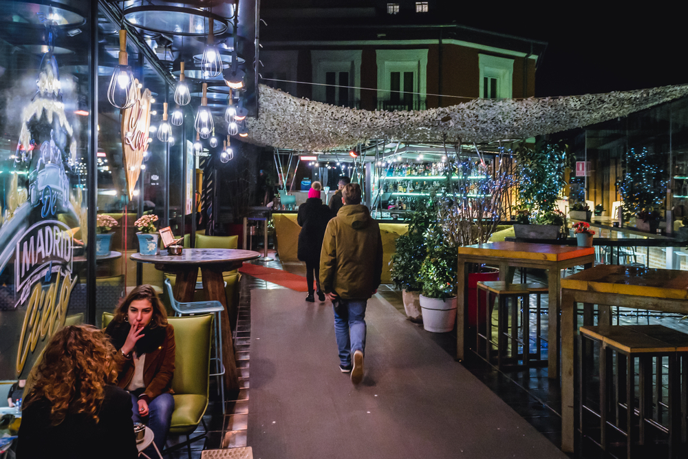 Live music in Madrid: People sitting at a bar in Chueca at night