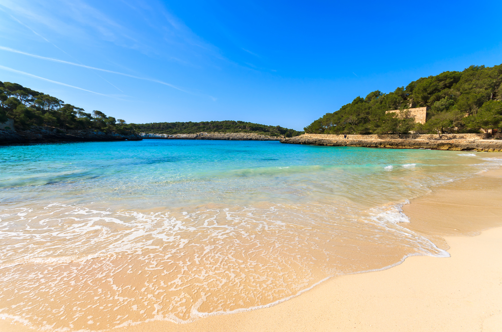 Sandy beach azure sea water bay sunny day, Cala Mondrago, Majorca island, Spain