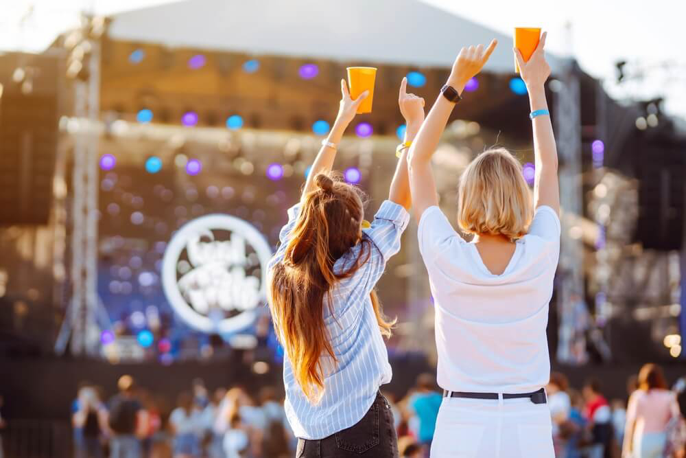 Music festivals in Europe: Two women dancing in a crowd at a festival