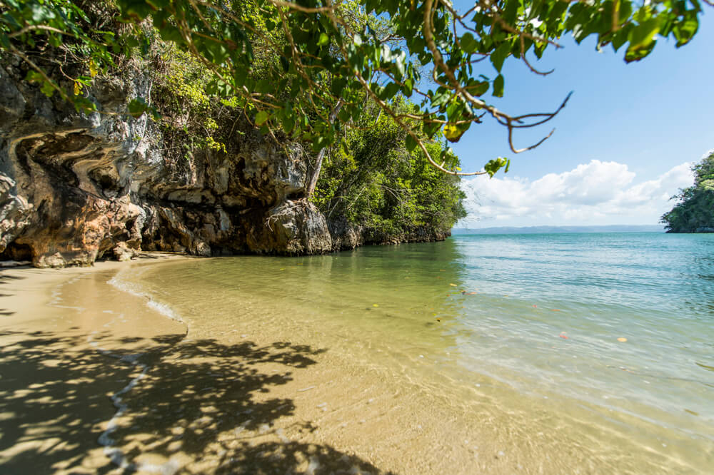 Tropischer Strand mit Karstfelsen.