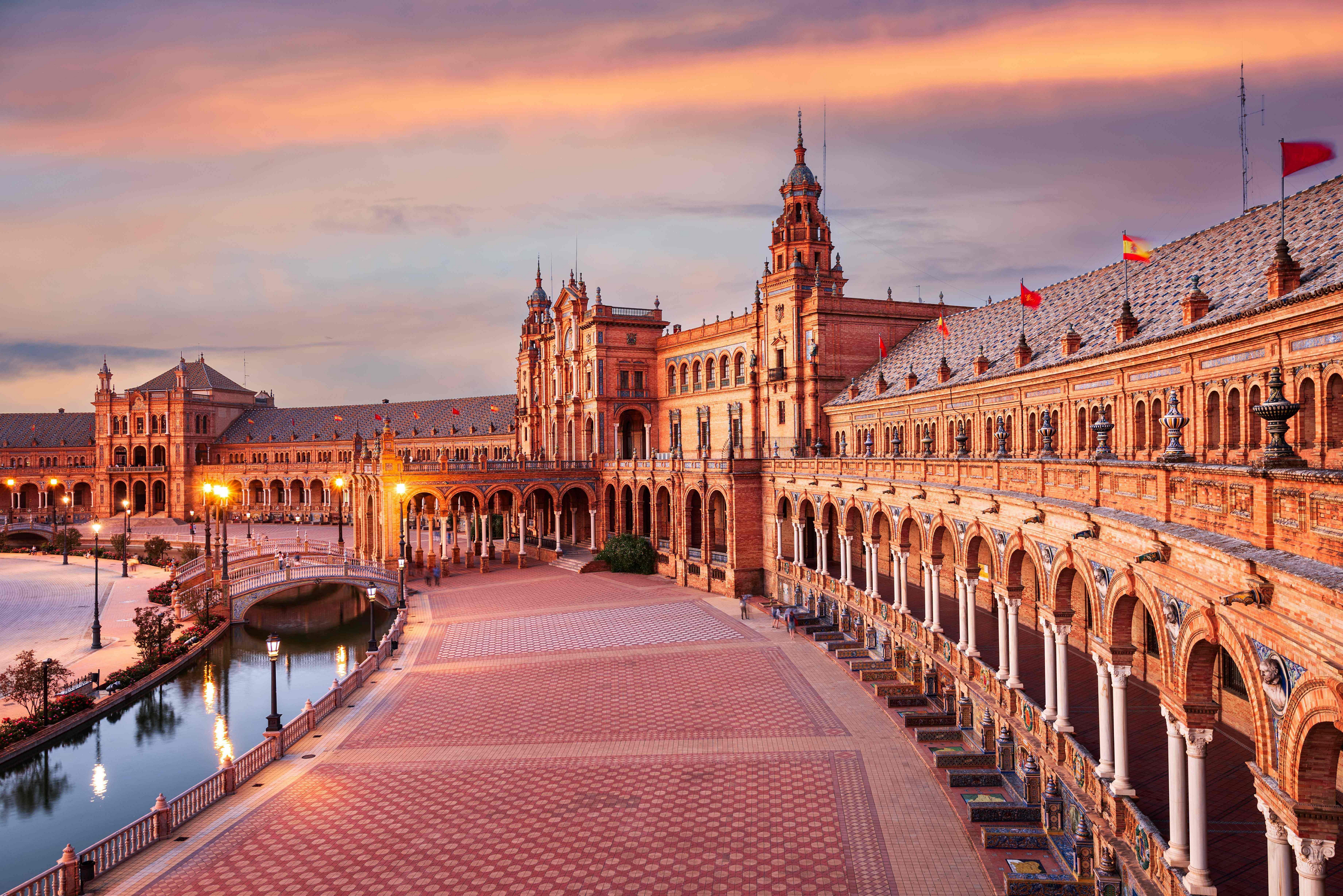 Plaza de España: A view of the baroque building overlooking Seville’s Plaza de España at sunset