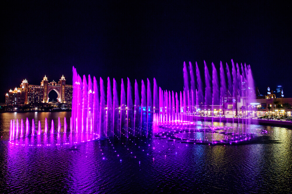 Dubai Mall: A view of Dubai Mall from outside with a light show at night