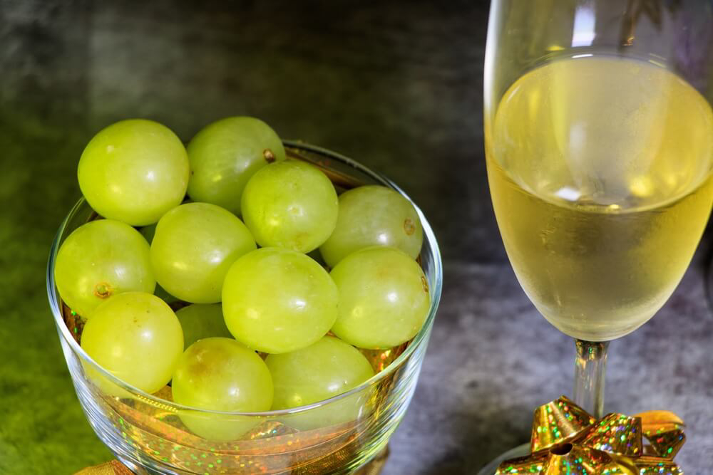 Strange New Year’s Traditions: A bowl of 12 grapes and a glass of champagne