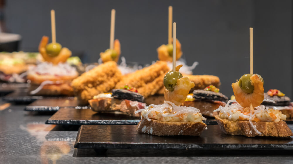 A table full of plates of Basque tapas bites Photo