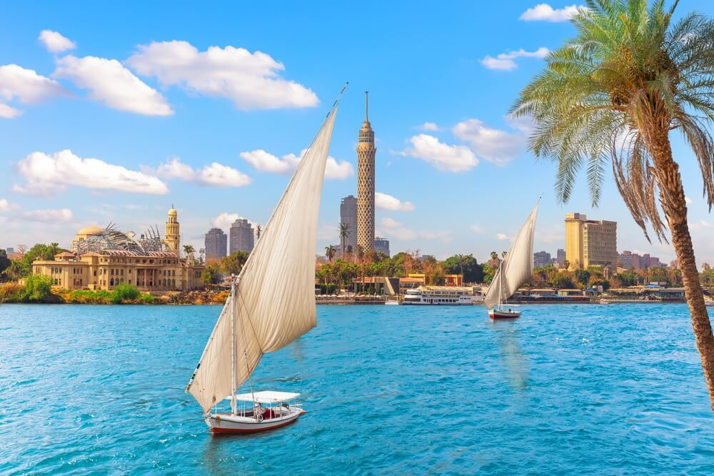 Felucca: Two small sailing boats with billowing sails on the Nile River