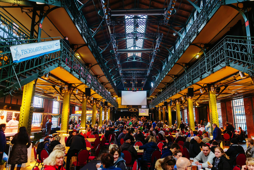 Altona Fish Market: A busy market hall full of people sitting and eating fish and seafood