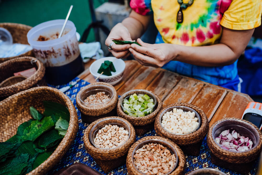 Places to visit in Phuket city: Woman sitting at a table with food bowls in front of her