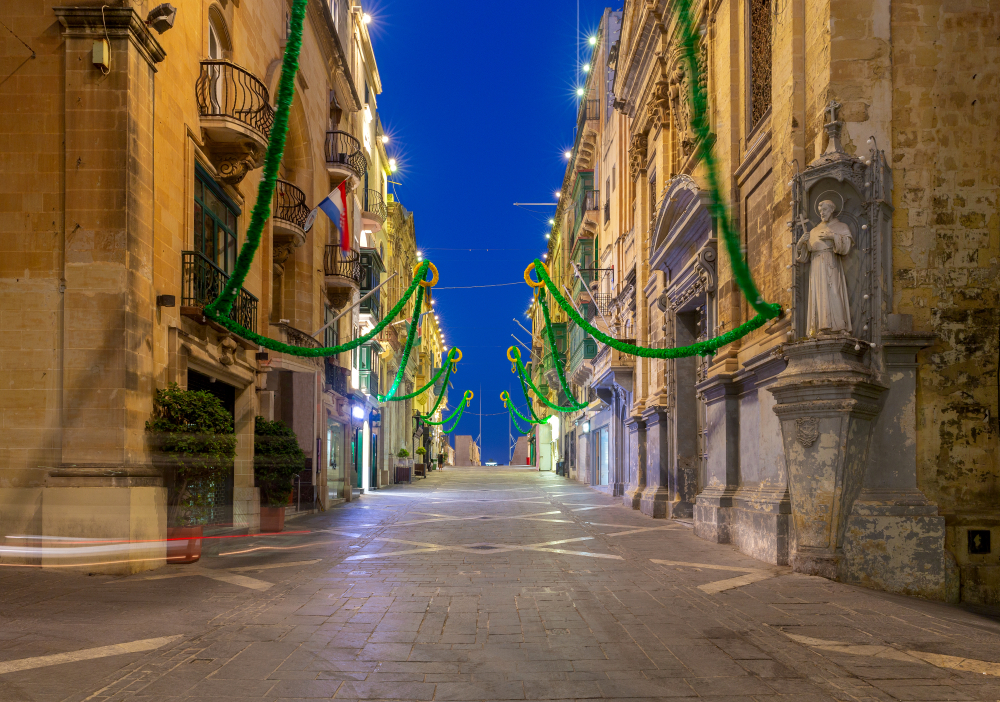 Republic Street Valletta: Old stone buildings lining a paved street decorated for a fair