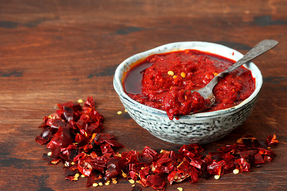 Tunisian harissa paste: Chillies on a wooden table