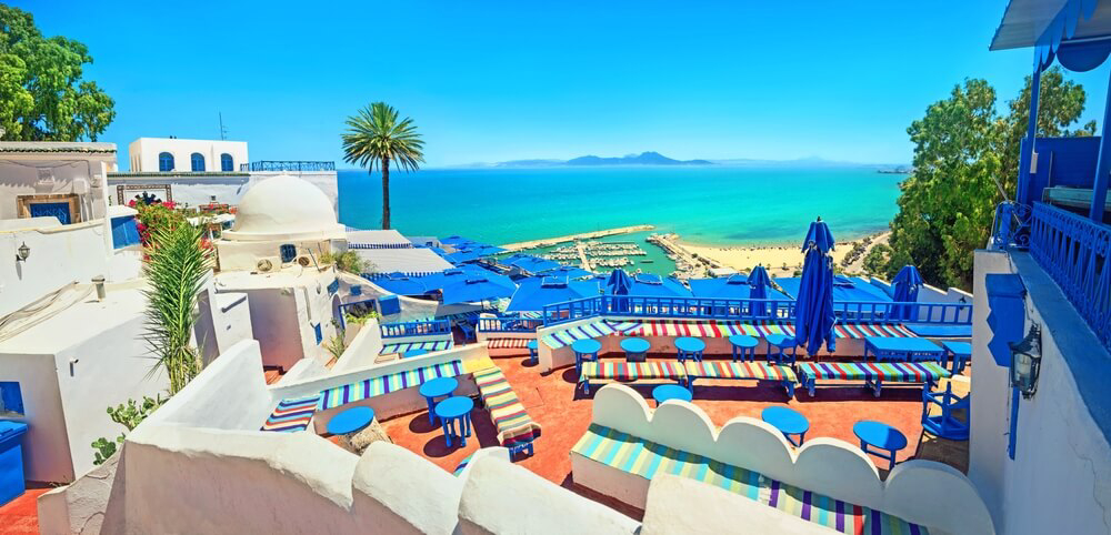 Sidi Bou Said: A view of a picturesque white and blue rooftop cafe on the coastline