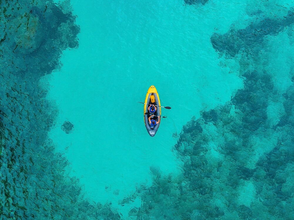 Watersports in Mallorca: A lone kayak on crystal clear waters in the middle of the sea