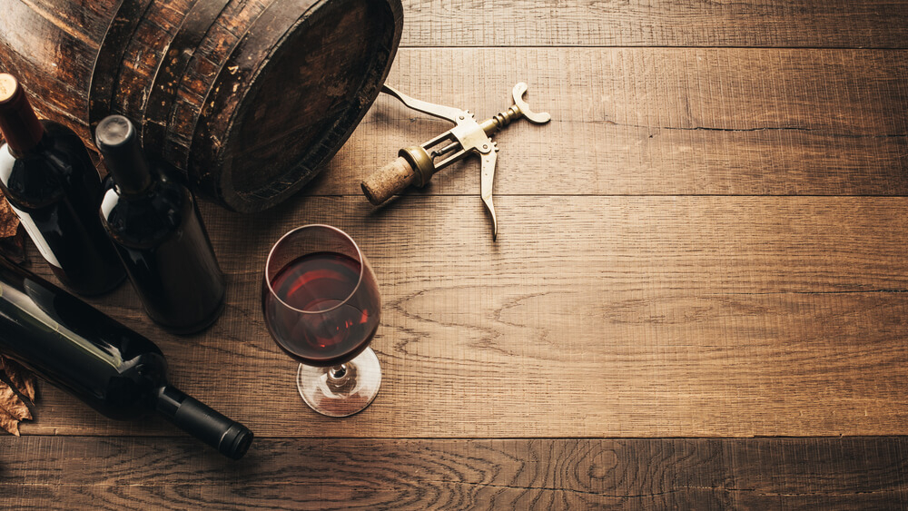 Wine regions of Spain: A wine glass on a wooden table with vineyard views